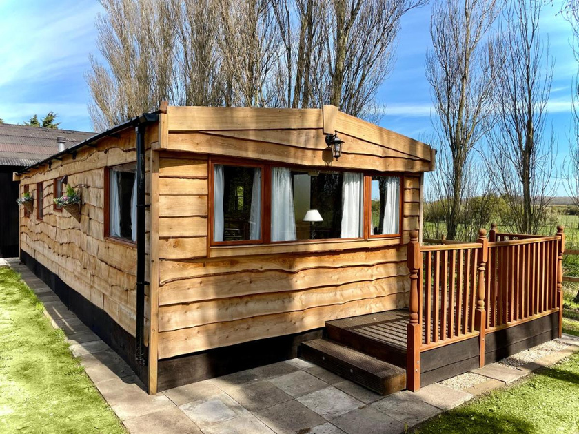 a static caravan clad with waney edge wood