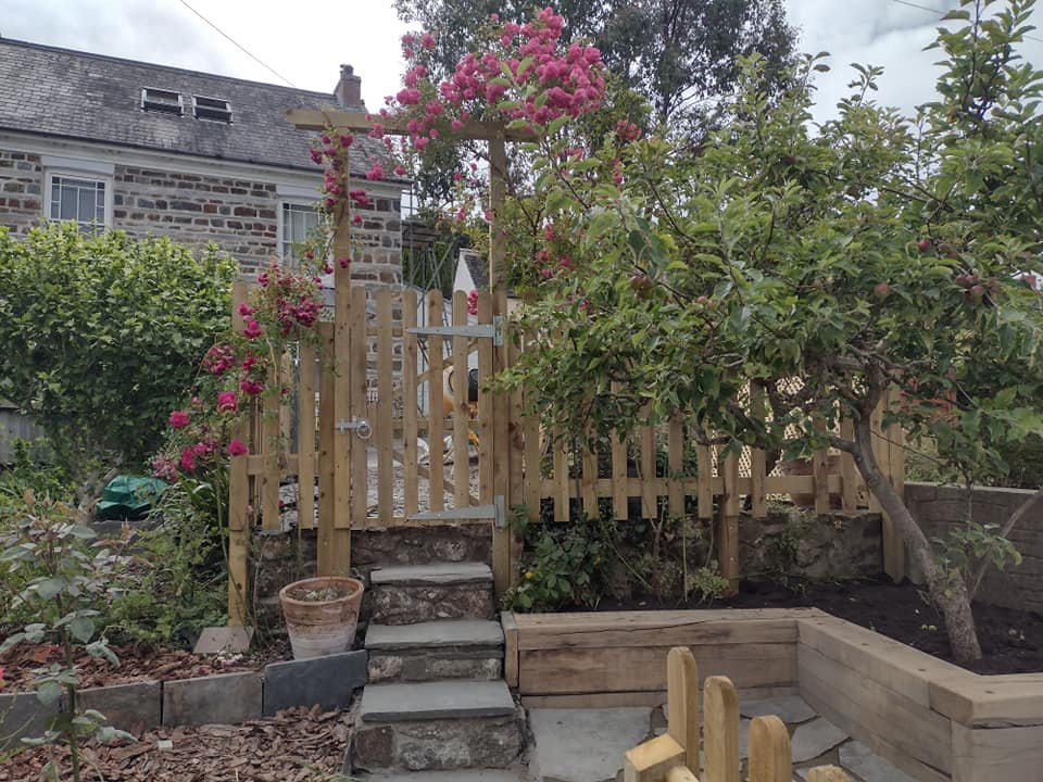 a garden with steps and fence