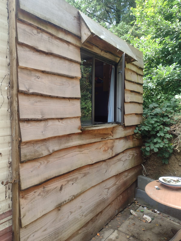 a wooden clad caravan