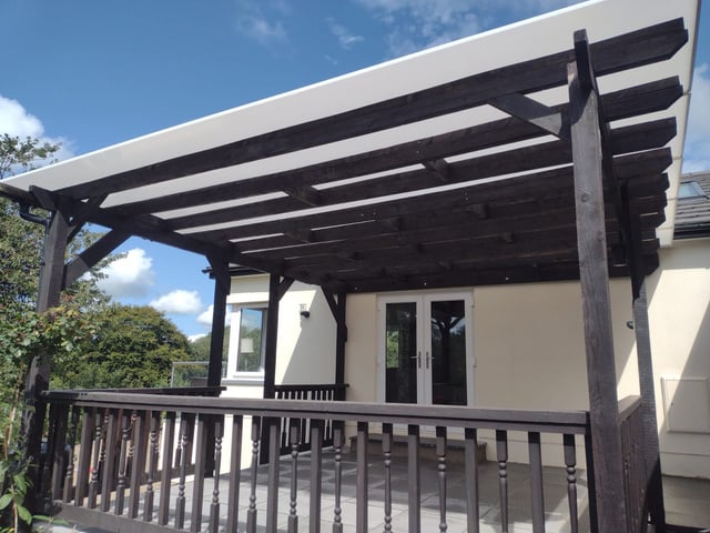 a wooden pergola over a patio