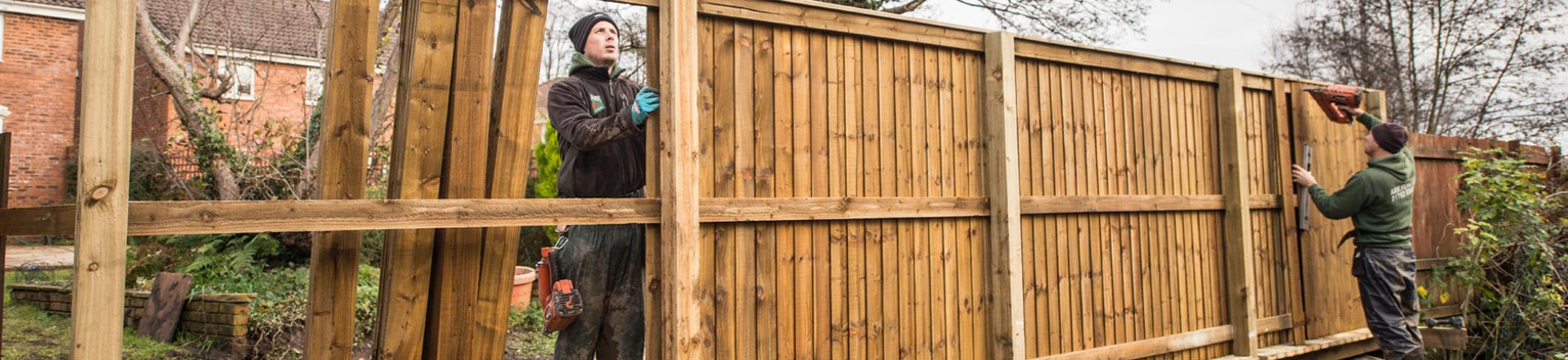 a man putting up a fence