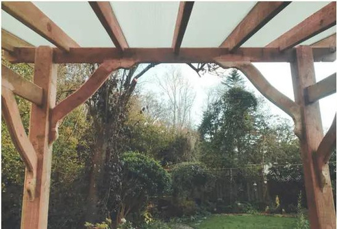 a wooden pergola from bluestone landscaping