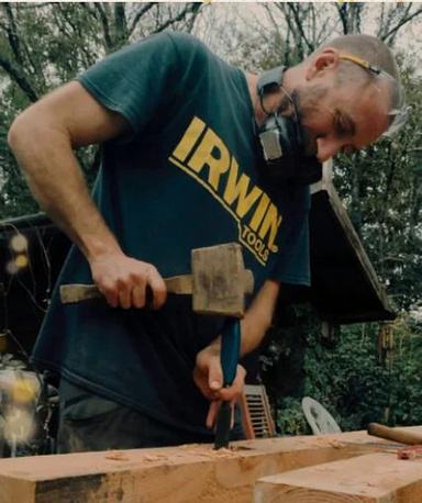 Nick from bluestone landscaping working on wood